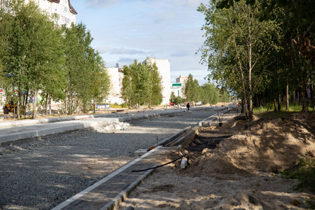 Repair of the road in the center of the city of Noyabrsk on Yamal in summerの写真素材