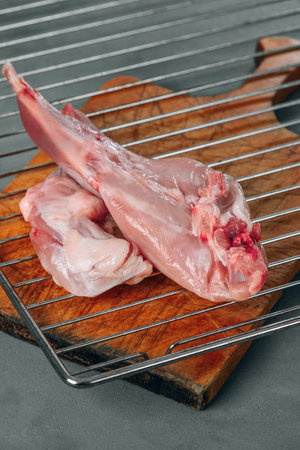 Rabbit meat raw. Metal grill and vintage wooden board.の写真素材