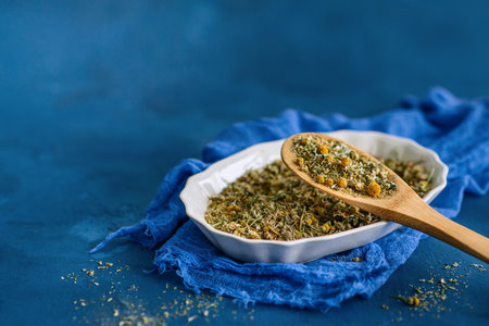 Dried chamomile or chamomile flowers   on a blue backgroundの写真素材