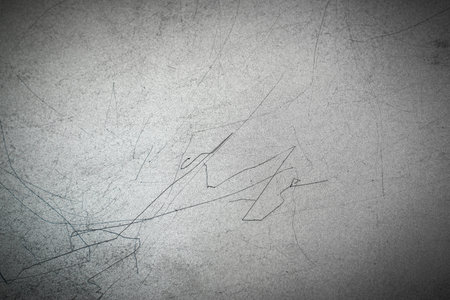 Texture of metal with long black scratches on the surface. Gray metallic horizontal  background.