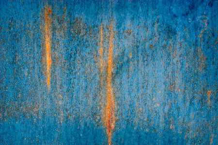 Blue yellow texture of rusty metal. Corrosion and bright transitions rust on the surface of the iron door close-up. Abstract construction grunge background.の写真素材