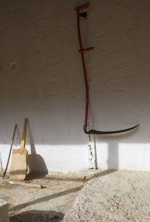 Scythe on the wall in the village house in Turkeyの写真素材