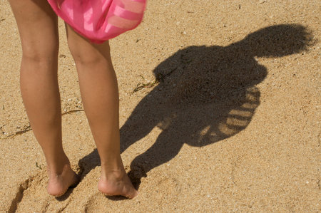Woman's shadow on the beach of Baliの写真素材