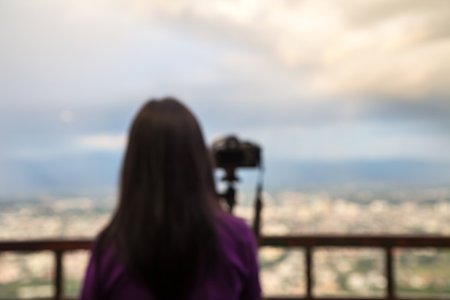 Defocused photographer taking photos the city from viewpointの写真素材