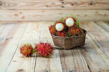 Fresh rambutan in wooden Basketの写真素材