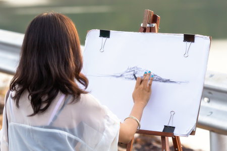 Young artist sketching a landscape, soft focusの写真素材