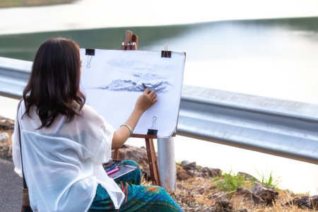 Young artist sketching a landscape, soft focusの写真素材