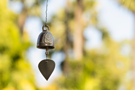 Old buddhist brass bell against defocused backgroundの写真素材
