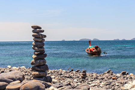 Smooth stones stacked on each other on the beach. Tower of stones for meditation on a seaの写真素材