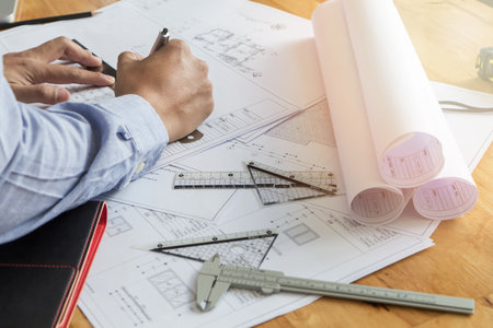 architect drawing on blueprint architectural concept