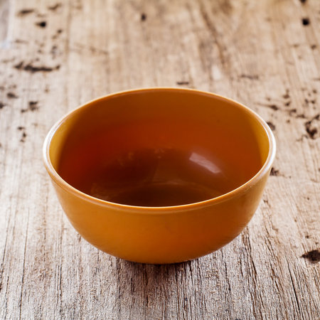 brown bowl on old wooden tableの写真素材