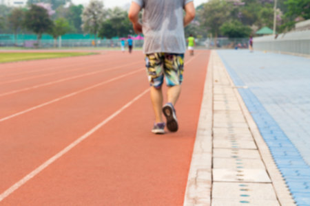 Blurred background of a man jogging on track