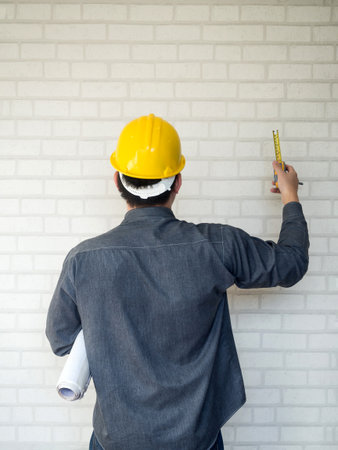 Back view of engineer on white wallの写真素材