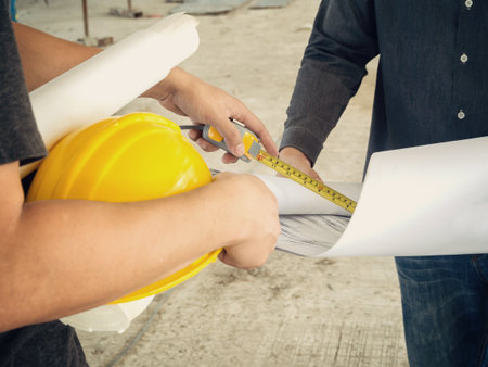 Engineer discussing with foreman about project in building construction site