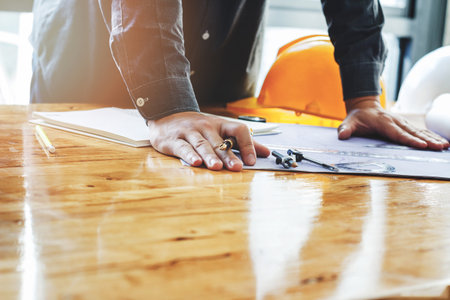 Architect holding a pen on project blueprint, architectural conceptの写真素材