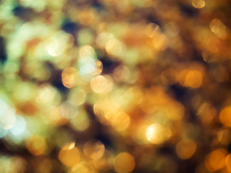 Abstract golden bokeh light on black backgroundの写真素材