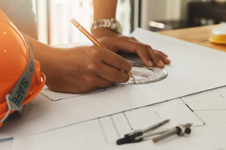 Architect or engineer working on blueprint, architectural concept