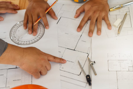Architect or engineer working on blueprint, architectural concept. Engineer discussing with...