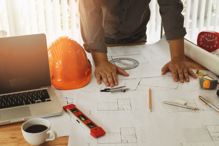 An architect or engineer working on blueprint, architectural concept
