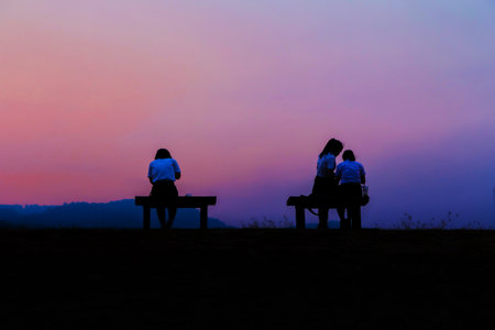 Silhouette of people in activity at evening twilight with motion blurの写真素材
