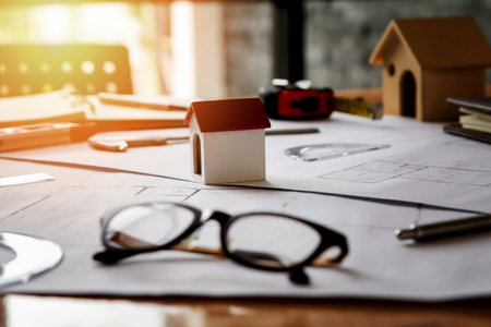 A architects house model with plan and blueprintsの写真素材