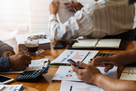 Business team meeting and discussing project plan. Businessmen discussing together in meeting room. Professional investor working with business project together. Finance managers task.の写真素材