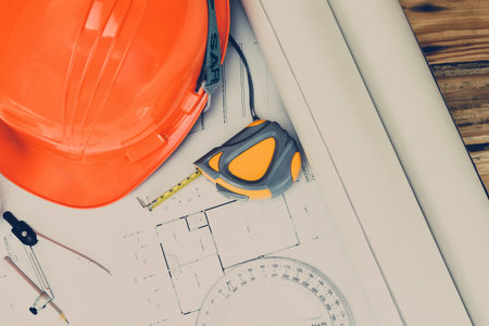 Helmet and measurement tool on blueprint, architectural conceptの写真素材