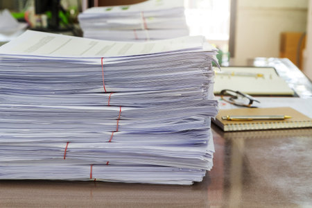 Close up of business documents stack on desk , report papers stack