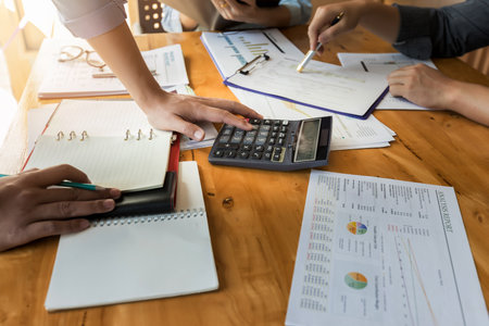 Business team meeting and discussing project plan. Businessmen discussing together in meeting room. Professional investor working with business project together. Finance managers task.の写真素材