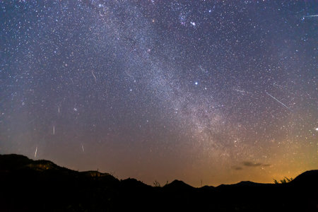 Geminid Meteor Shower and the Milky Way Over a mountain. Geminid Meteor in the night sky