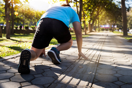 Ready to go! Close up cropped low angle photo of shoe of athlete man in running start pose on road...