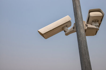 CCTV camera in security system in urban city with sky background in security concept