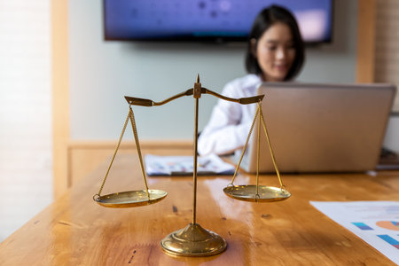 Gold brass balance scale over with lawyer background.の写真素材