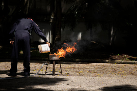 Firefighters in show the heat of a flame and the use of fire extinguishers.の写真素材