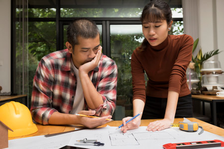Group of two coworkers working with blueprint in office. co-working teamwork concept.の写真素材