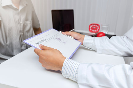 A doctor consults patient while sitting at the table in office. Medicine and health care concept.の写真素材