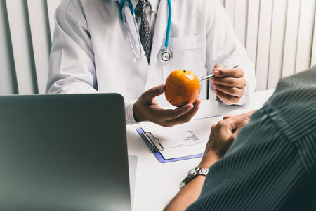 Nutritionists consulting about nutrition with a man to choose eating fresh fruits and vegetables.の写真素材