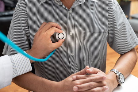 Doctor Checking Patient With Stethoscope. Doctor listening to patient chest with stethoscope in his...