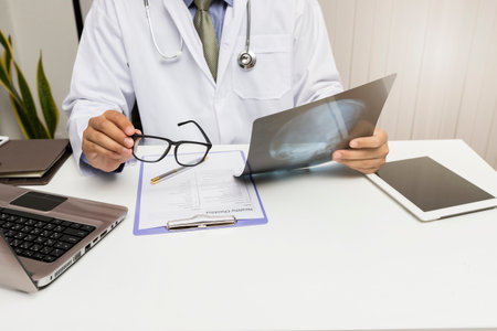 Medicine and health care concept. Doctor diagnose and analyze on x-ray film of patient.