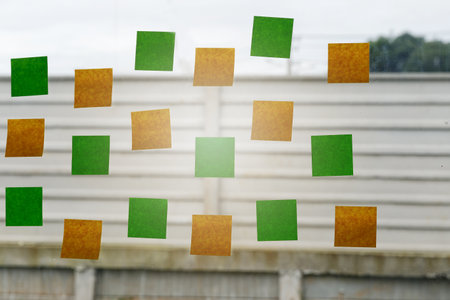 Blank Sticky notes on a glass of window in the office. Brainstorming concept.の写真素材