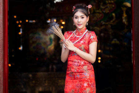 Concept to celebrate Chinese New Year, Vegetarian Festival : Chinese woman in a red cheongsam dress...