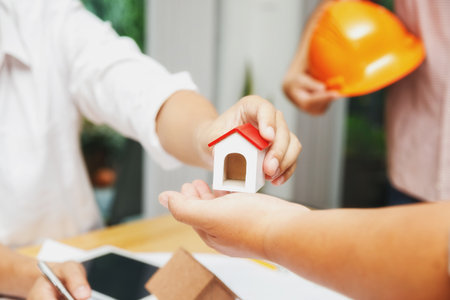 Confident team of architect working together in a office.Then discussing about new startup project on desk. Architect discuss with engineer about project in office, architectural conceptの写真素材