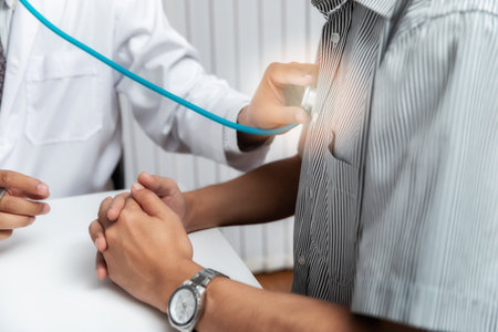 Doctor Checking Patient With Stethoscope. Doctor listening to patient chest with stethoscope in his...