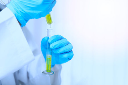 Researcher or scientists loads liquid sample into test tube in laboratory. Researchers are...