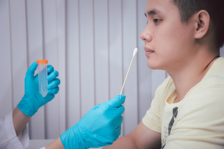Doctor or medical staff is collecting secretions from patient for examination in the lab. Pandemic Coronavirus, COVID-19.の写真素材
