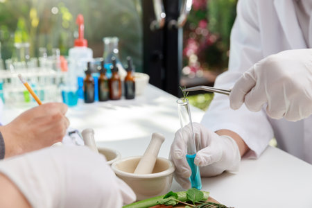 The scientist or doctor make herbal medicine from herb in the laboratory on the table. Herb medicine with herbal the organic natural in the laboratory.の写真素材