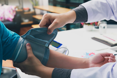 Doctor measuring blood pressure of the patient in the hospital, Medical and health care concepts.