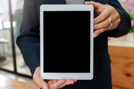 Man holding digital tablet in hand. Business man showing digital tablet with blank screen.の写真素材
