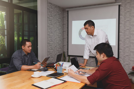 Business team meeting and discussing project plan. Businessmen discussing together in meeting room....