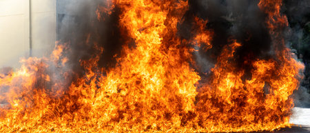 Flames caused by the explosion of the oil. Demonstration of water on oil fire. Blaze fire flame...